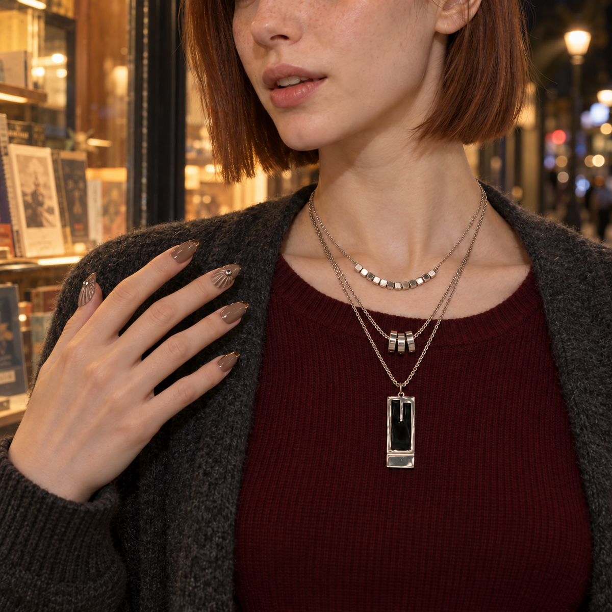 Set 04: model wearing the same layered jewelry and matching nails on her fingers.