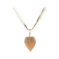 Date Night possible look 1 of 4: Layered chains with a detailed leaf-shaped pendant. One surprise two-necklace set per box.